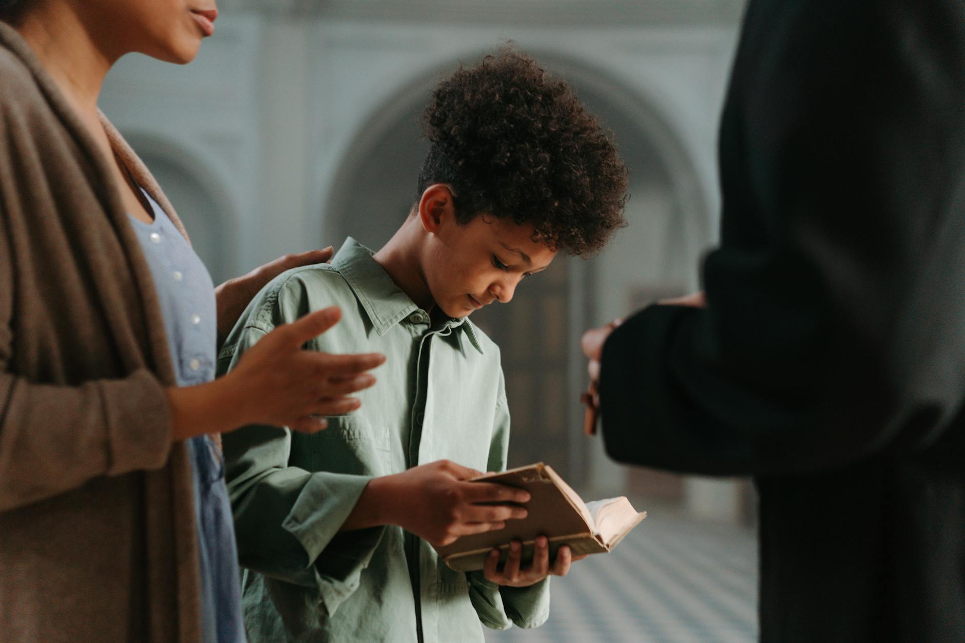 a boy holding a bible