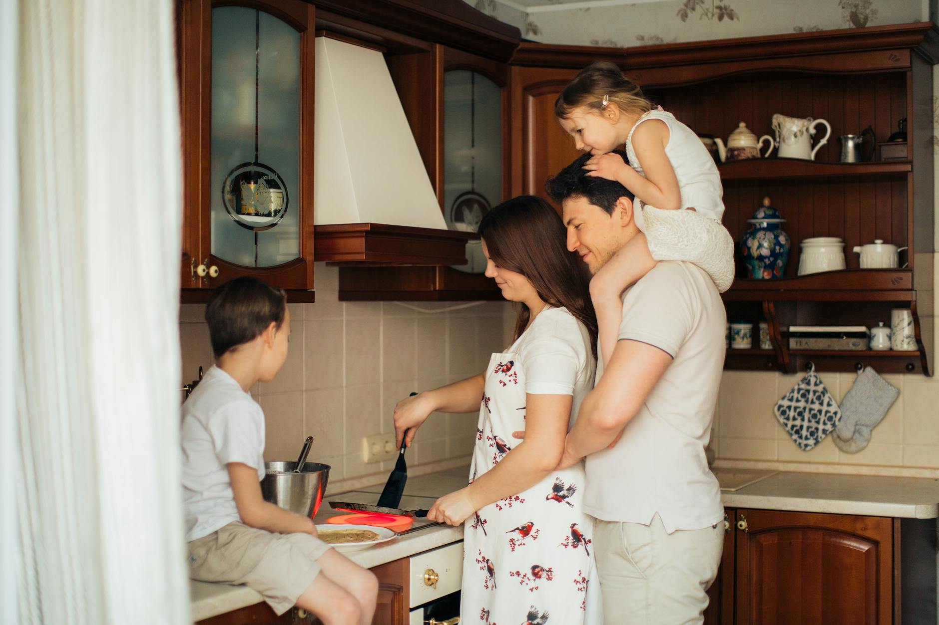 photo of woman cooking near her family
