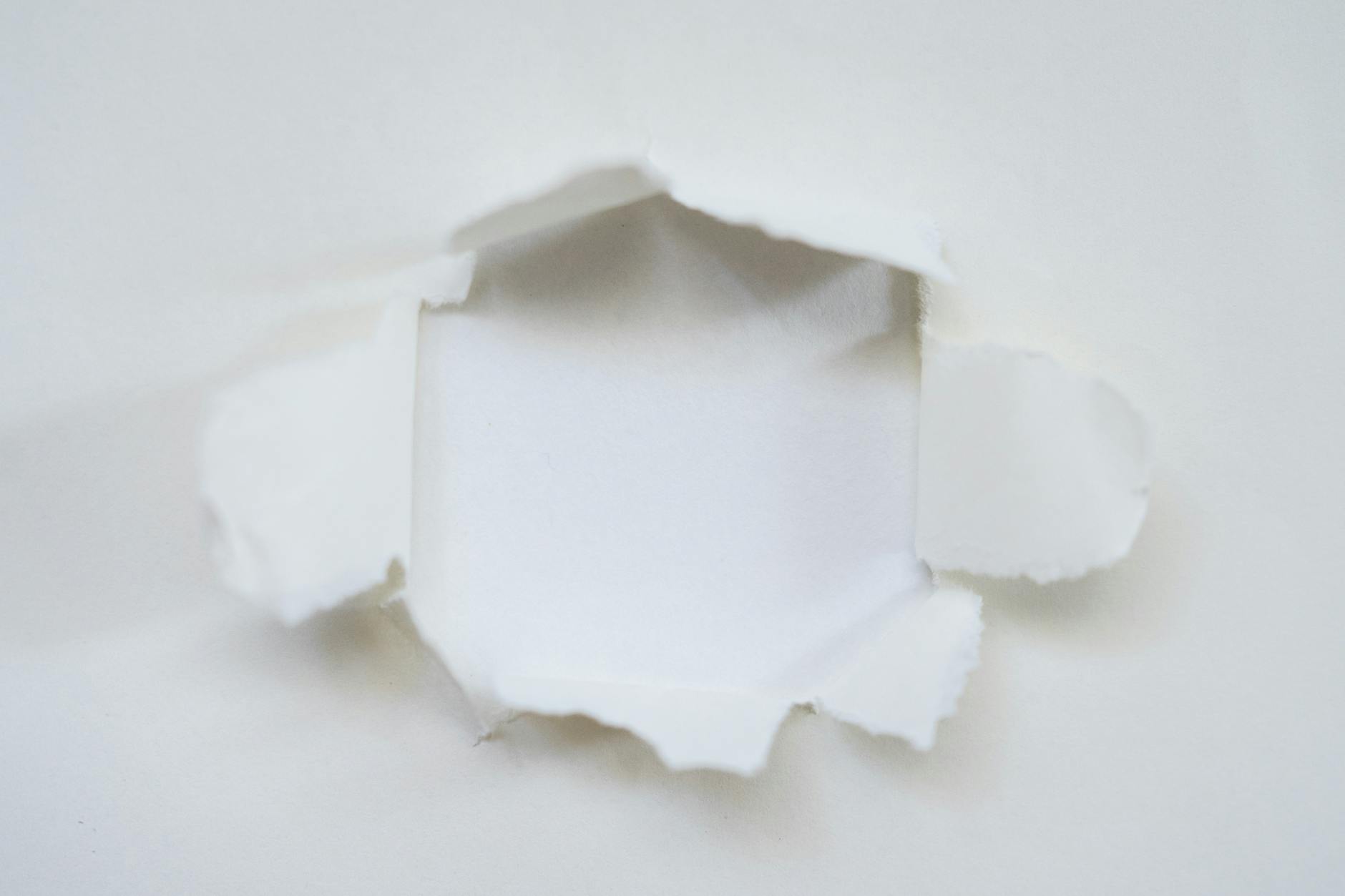a white paper with a hole in it
